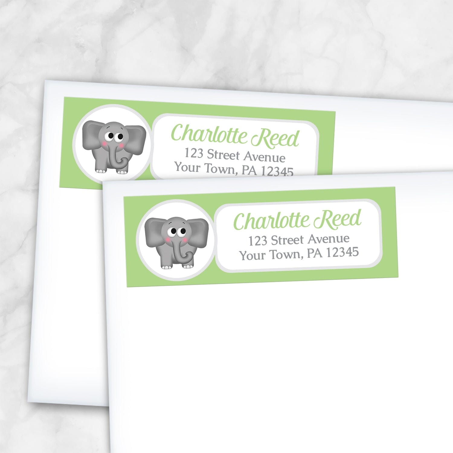 2 Cute Elephant Green Address Labels shown on white envelopes on a marble surface