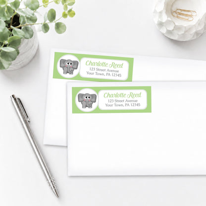 Cute Elephant Green Address Labels, shown on white envelopes, on a white surface with a pen and plant.
