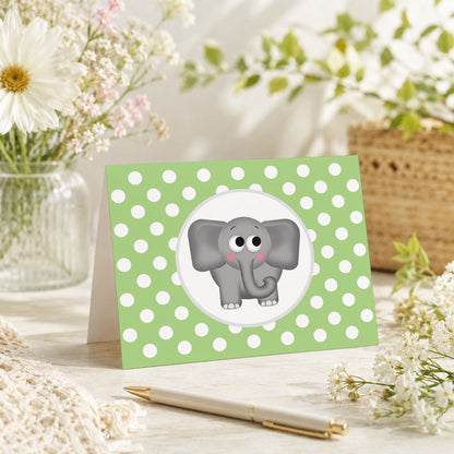 Cute Elephant Green Polka Dot Note Card shown on a tabletop with a vase, spring and summer flowers, and a pen.