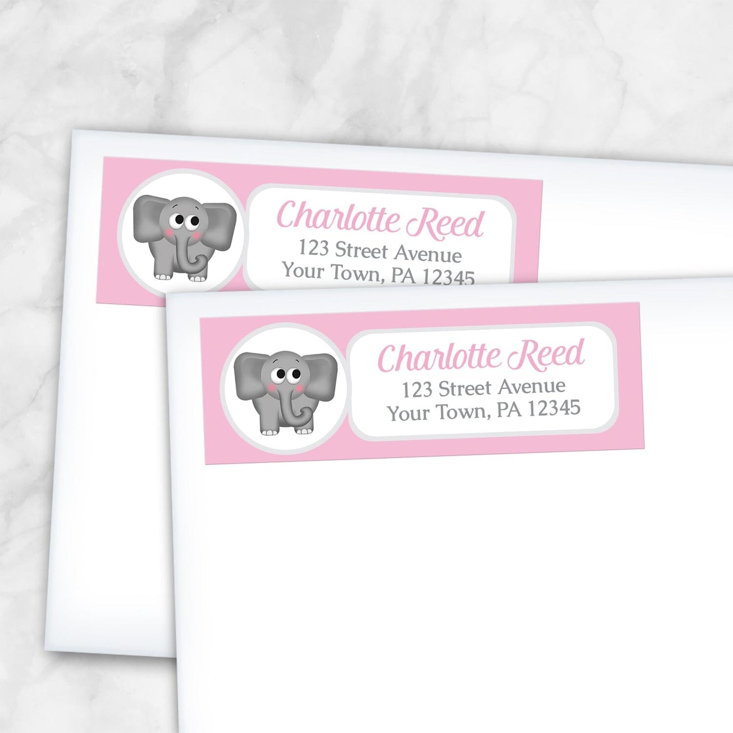 2 Cute Elephant Pink Address Labels shown on white envelopes on a marble surface