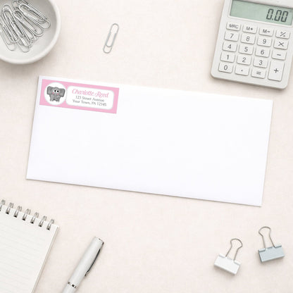 Cute Elephant Pink Address Label shown on a white envelope with everyday office supplies