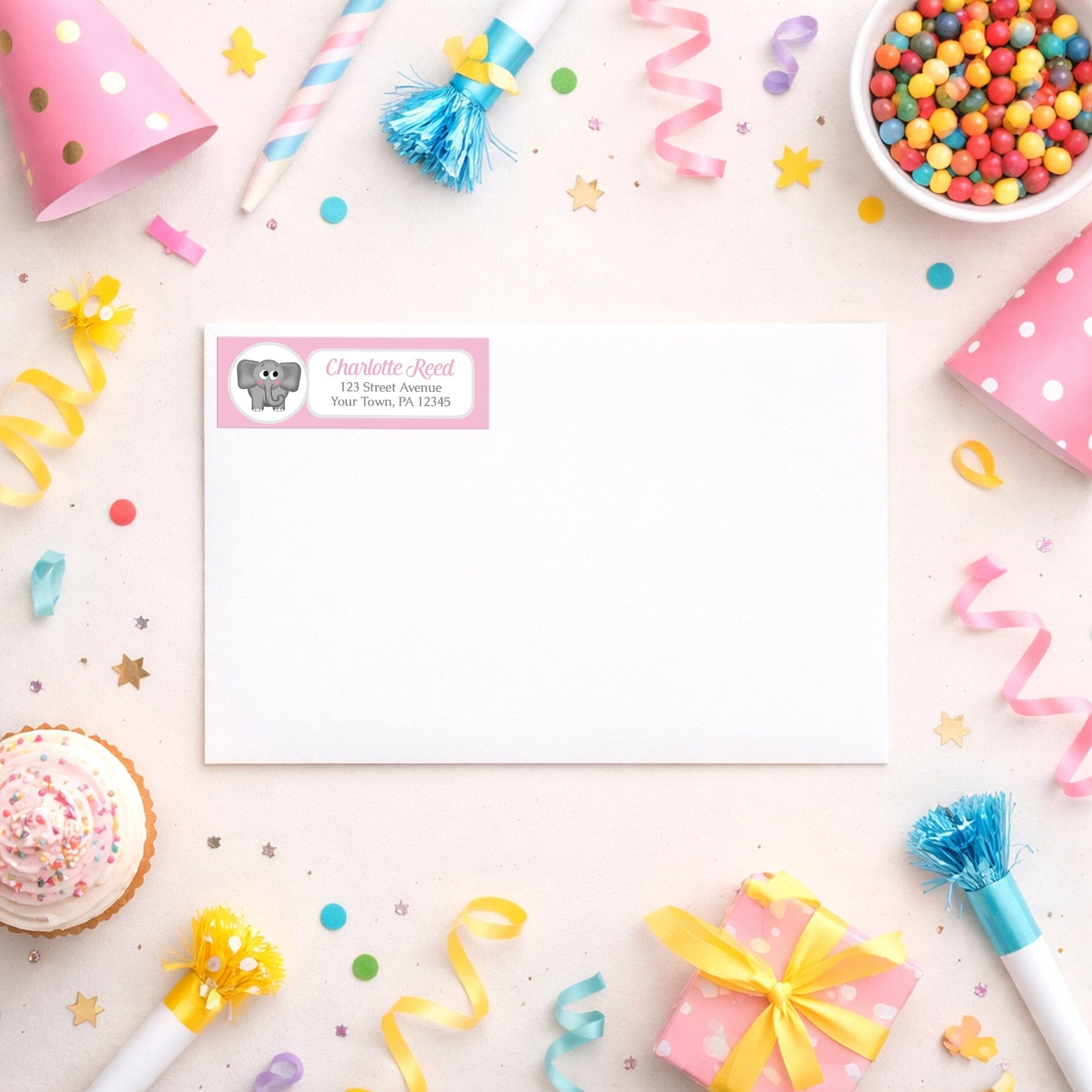 Cute Elephant Pink Address Label shown on a white envelope with party supplies