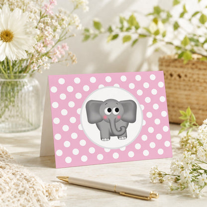 Cute Elephant Pink Polka Dot Note Card shown on a tabletop with a vase, spring and summer flowers, and a pen.