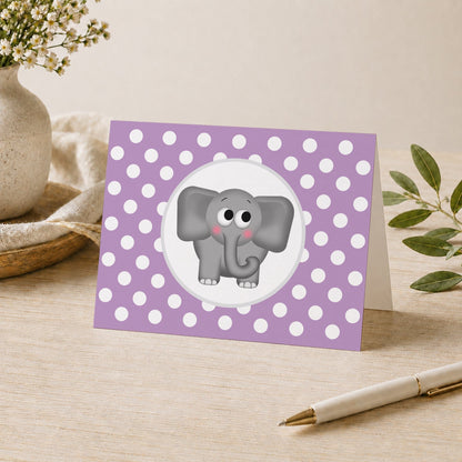 Cute Elephant Purple Polka Dot Note Card shown on a desk with a vase, plants, and a pen.