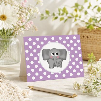 Cute Elephant Purple Polka Dot Note Card shown on a tabletop with a vase, spring and summer flowers, and a pen.