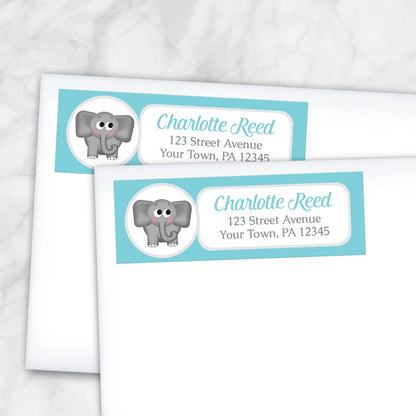 2 Cute Elephant Turquoise Address Labels shown on white envelopes on a marble surface