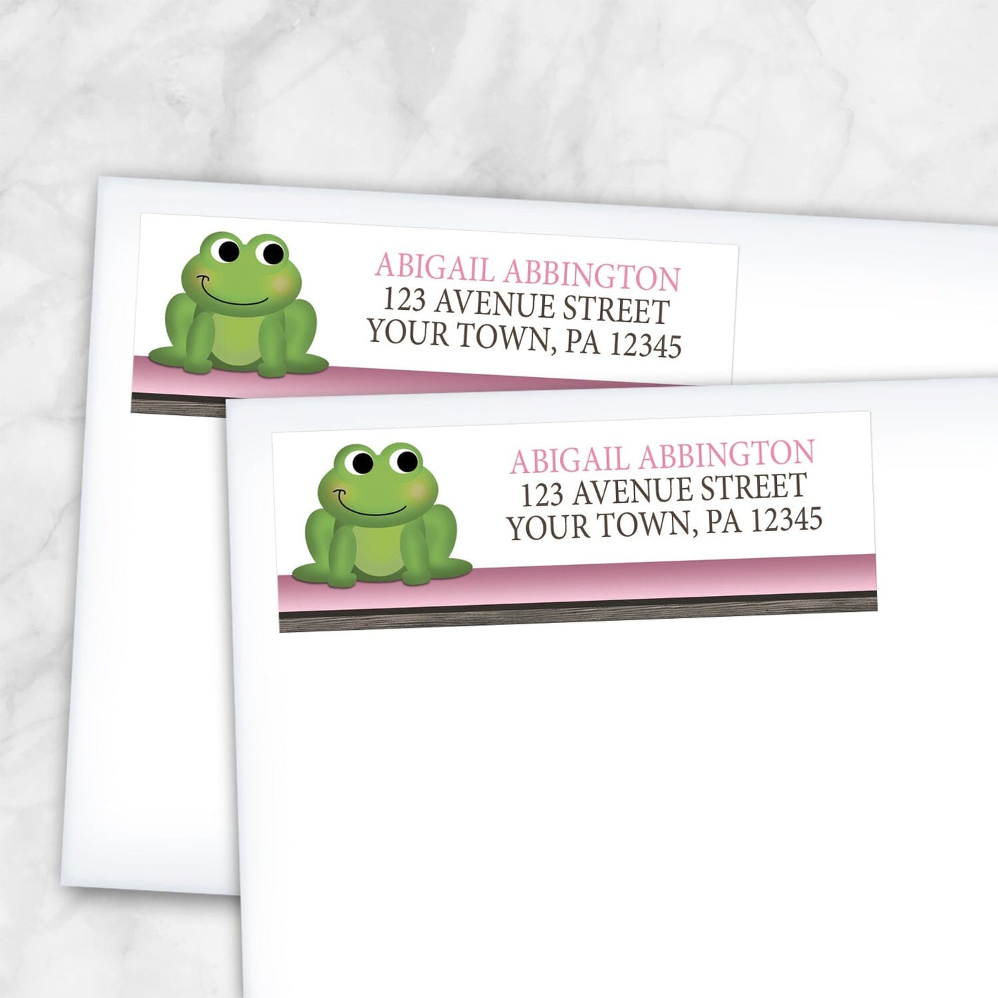 2 Cute Frog Green Pink Rustic Brown Address Labels shown on white envelopes on a marble surface