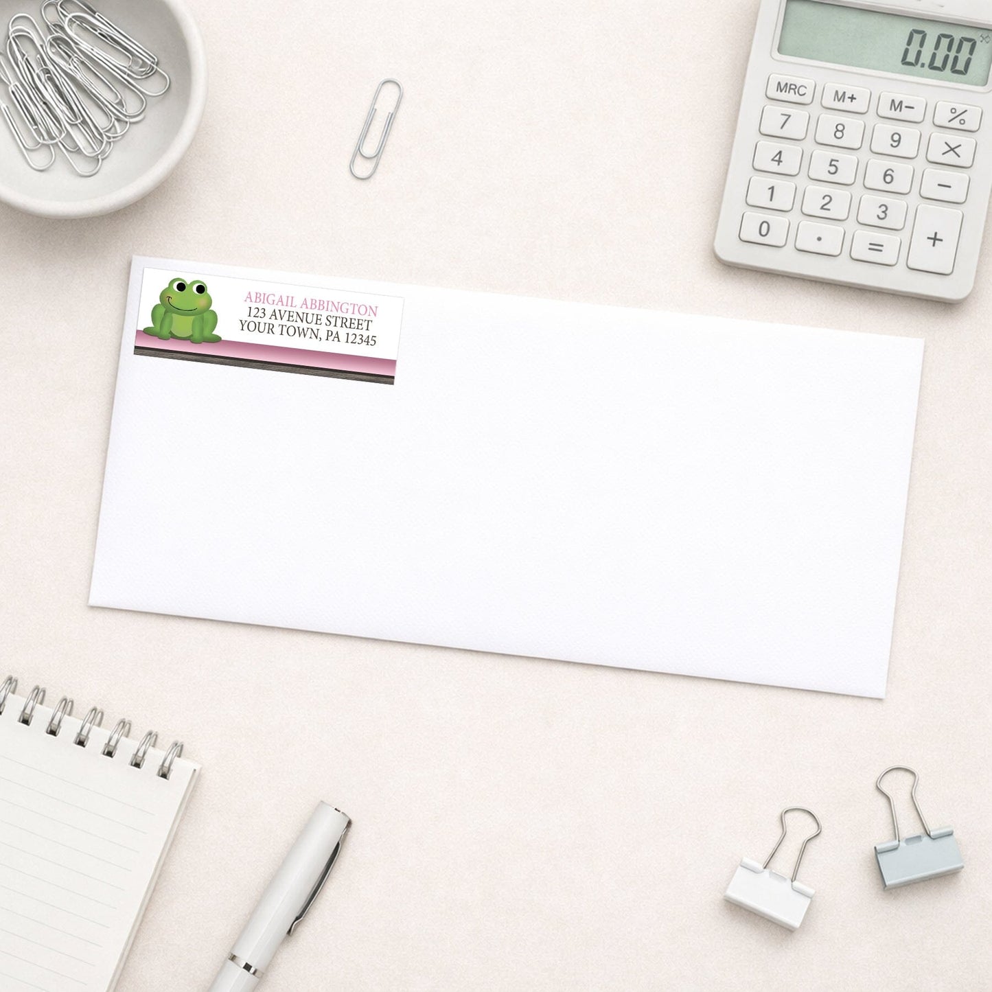 Cute Frog Green Pink Rustic Brown Address Label shown on a white envelope with everyday office supplies