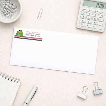 Cute Frog Green Pink Rustic Brown Address Label shown on a white envelope with everyday office supplies