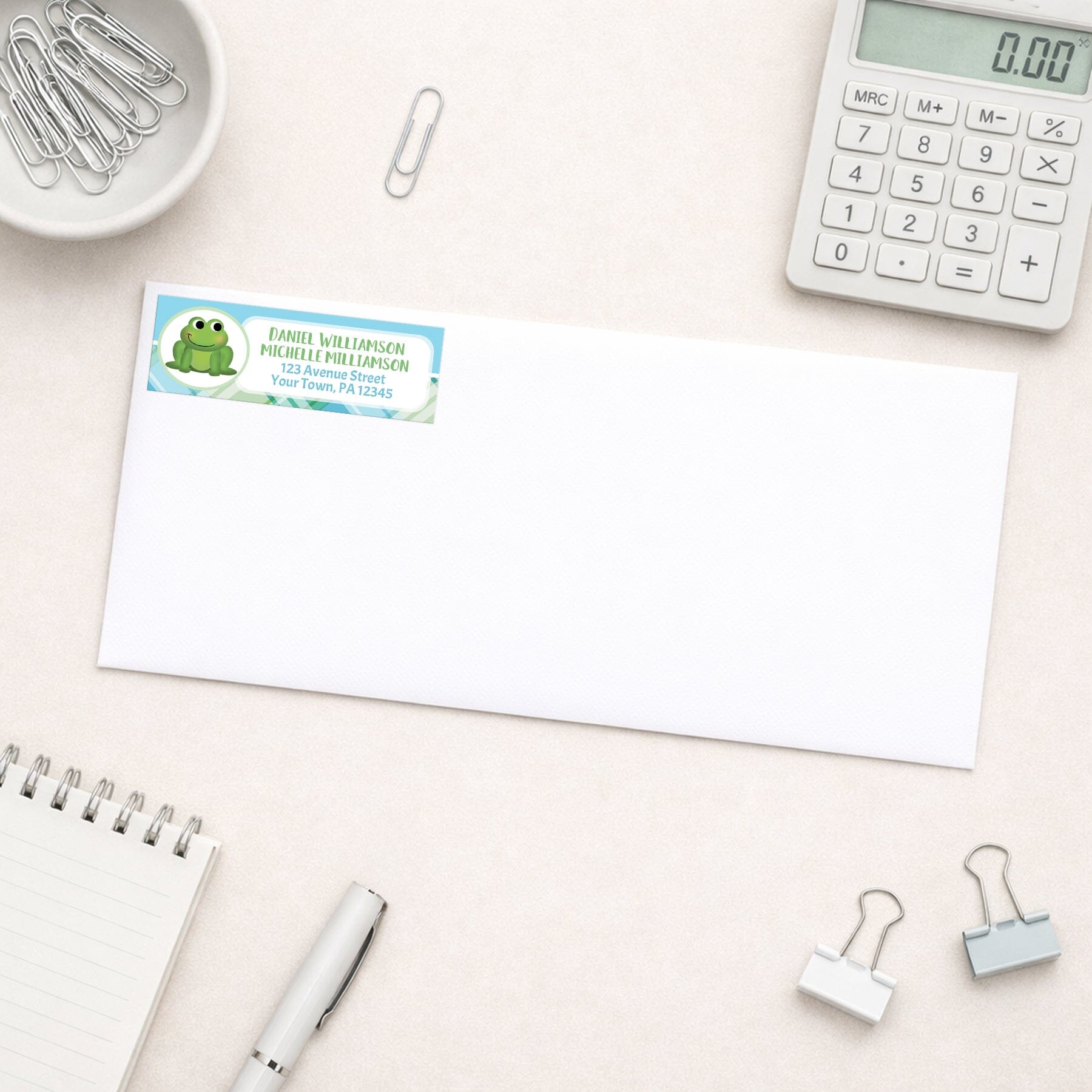 Cute Frog Green and Blue Plaid Address Label shown on a white envelope with office supplies