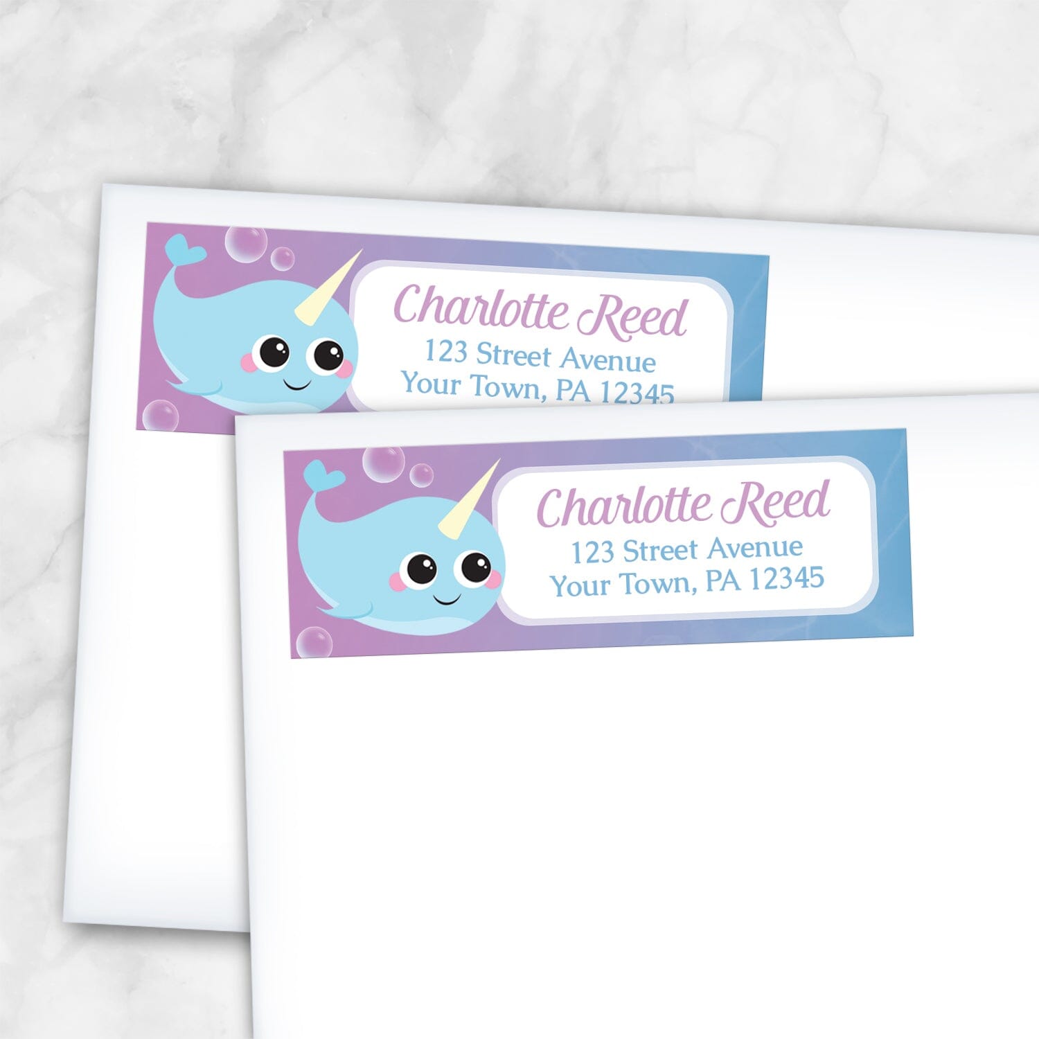 2 Cute Happy Narwhal Return Address Labels shown on white envelopes on a marble surface