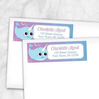 2 Cute Happy Narwhal Return Address Labels shown on white envelopes on a marble surface