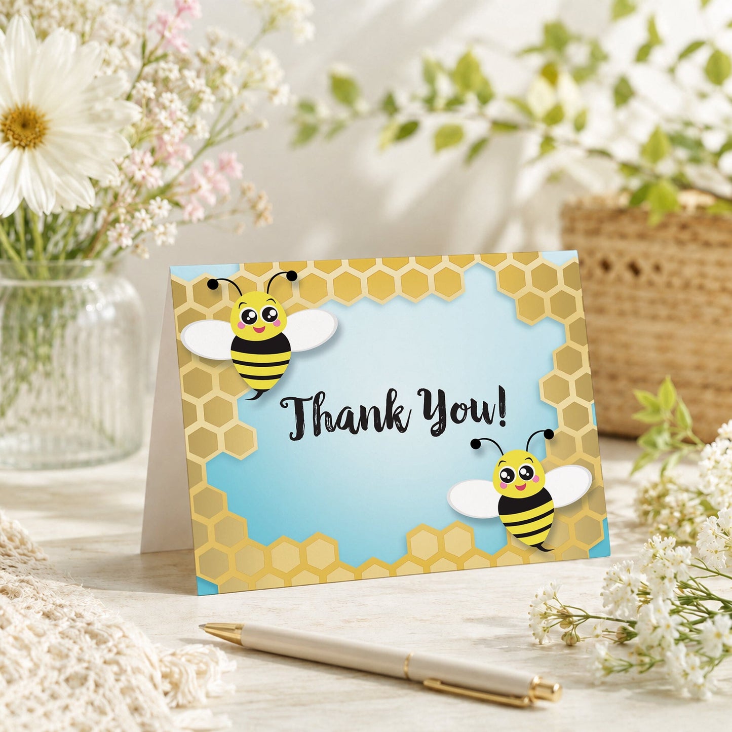 Cute Honeycomb Bee Thank You Card shown on a tabletop with spring and summer flowers, a vase, and a pen.