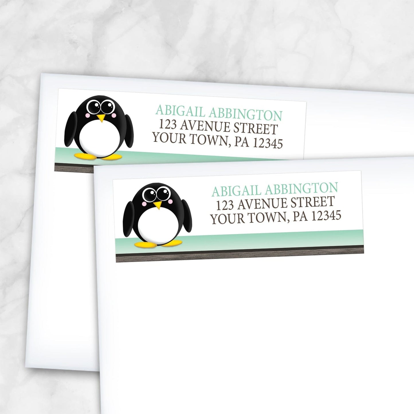 2 Cute Penguin Mint Green Rustic Address Labels shown on white envelopes on a marble surface