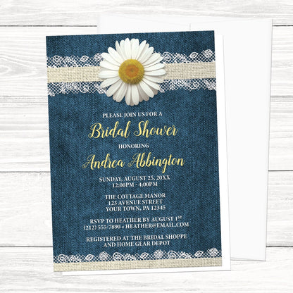 Daisy Burlap and Lace Denim Bridal Shower Invitation shown on a light wood surface with a white envelope.