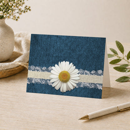 Daisy Burlap and Lace Denim Note Card shown on a tabletop with a vase, plants, and a pen.