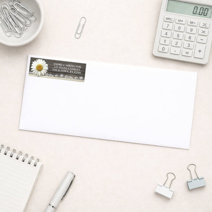 Daisy Burlap and Lace Wood Address Label shown on a white envelope with everyday office supplies