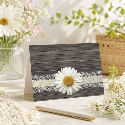 Daisy Burlap and Lace Wood Note Card shown on a tabletop with a vase, spring and summer flowers, and a pen.