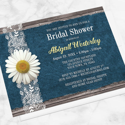 Daisy Denim and Lace Rustic Bridal Shower Invitation shown at an angle on a marble surface with a white envelope.