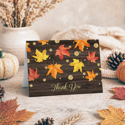 Falling Leaves with Gold Autumn Thank You Card shown on a tabletop with fall leaves and autumn decor.