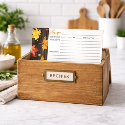 Wooden recipe box with the Falling Leaves with Gold Autumn Recipe Cards on a kitchen counter.