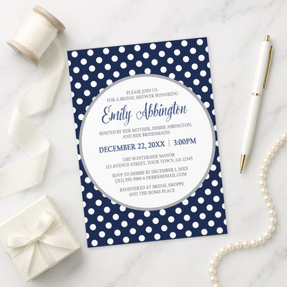 Gray Navy Blue Polka Dot Bridal Shower Invitation on a marble surface with ribbon, pen, and gift box.