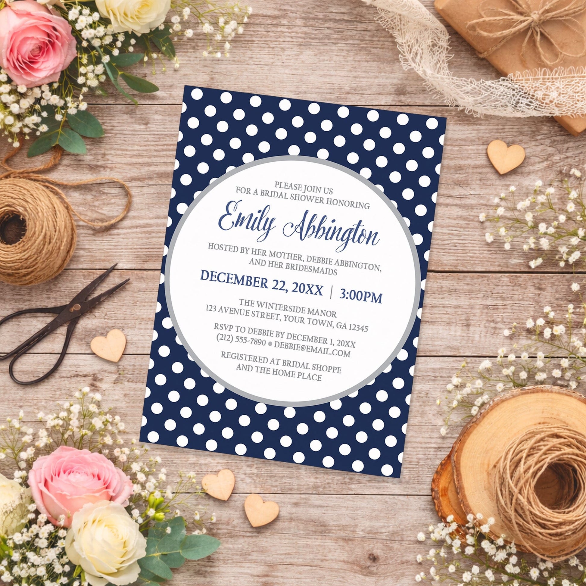 Gray Navy Blue Polka Dot Bridal Shower Invitation on a wooden surface with flowers and decorations.