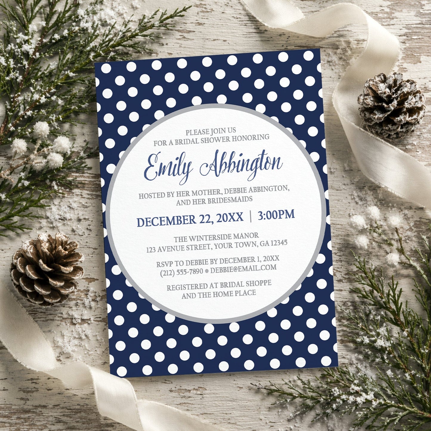 Gray Navy Blue Polka Dot Bridal Shower Invitation on a rustic wooden background with winter greenery and ribbons.