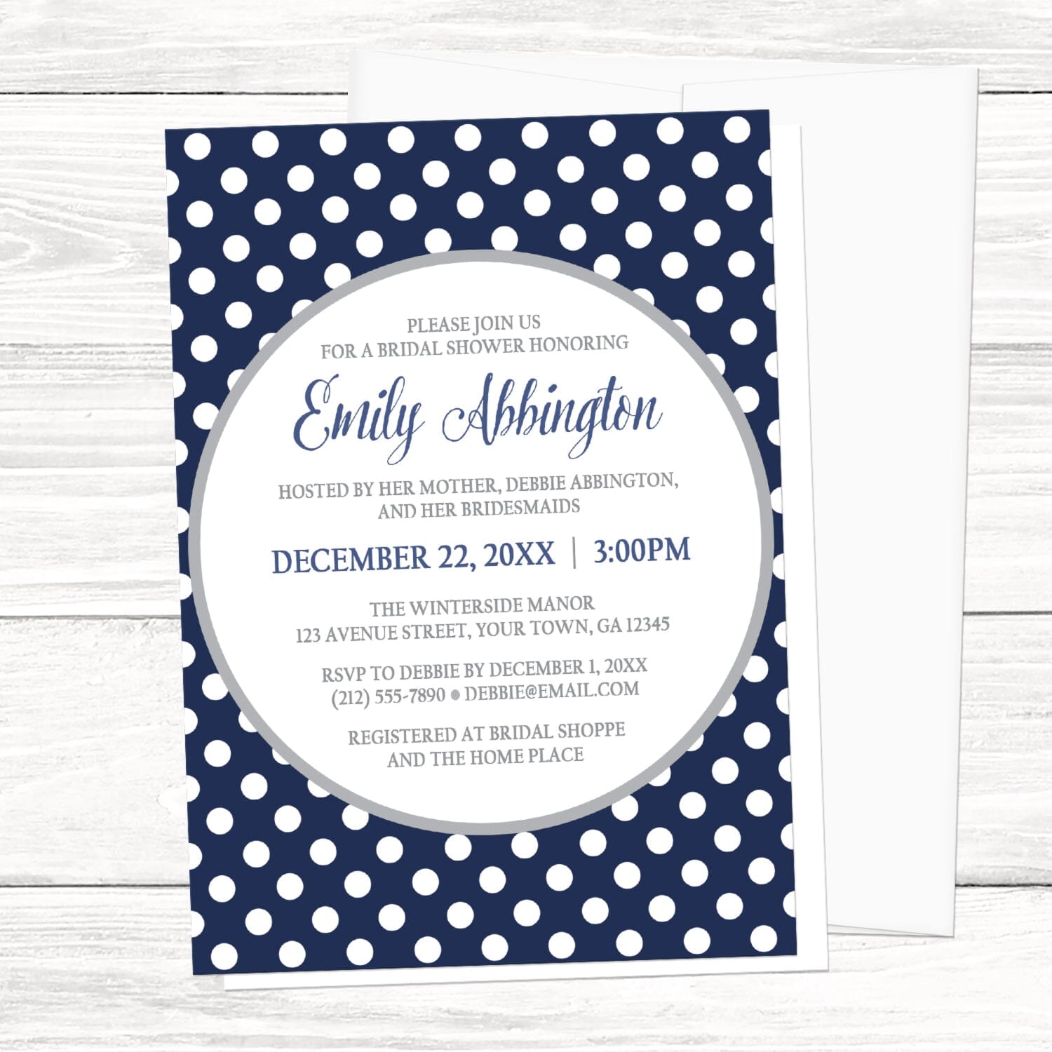 Gray Navy Blue Polka Dot Bridal Shower Invitation on a white wooden surface with a white envelope.