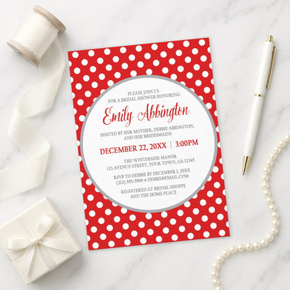 Gray and Red Polka Dot Bridal Shower Invitation shown on a marble surface with a white gift box, pen, ribbon, and pearls.