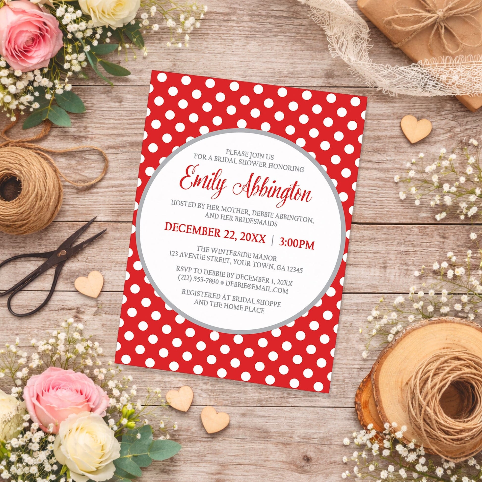 Gray and Red Polka Dot Bridal Shower Invitation shown on a country-inspired wooden surface with spring and summer flowers, small wood hearts, lace ribbon, and twine.