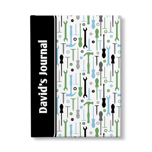 Personalized Green Blue Tools Pattern Journal at Artistically Invited. A custom book designed with a black color block wrapping around the spine area over an organized pattern of green, blue, black, and gray tools on the rest of the background. This handyman or contractor-inspired pattern includes hammers, screwdrivers, wrenches, nails, screws, and washers. Your personalized name and text of your choice is custom printed sideways in white over the black color block on the front near the spine.