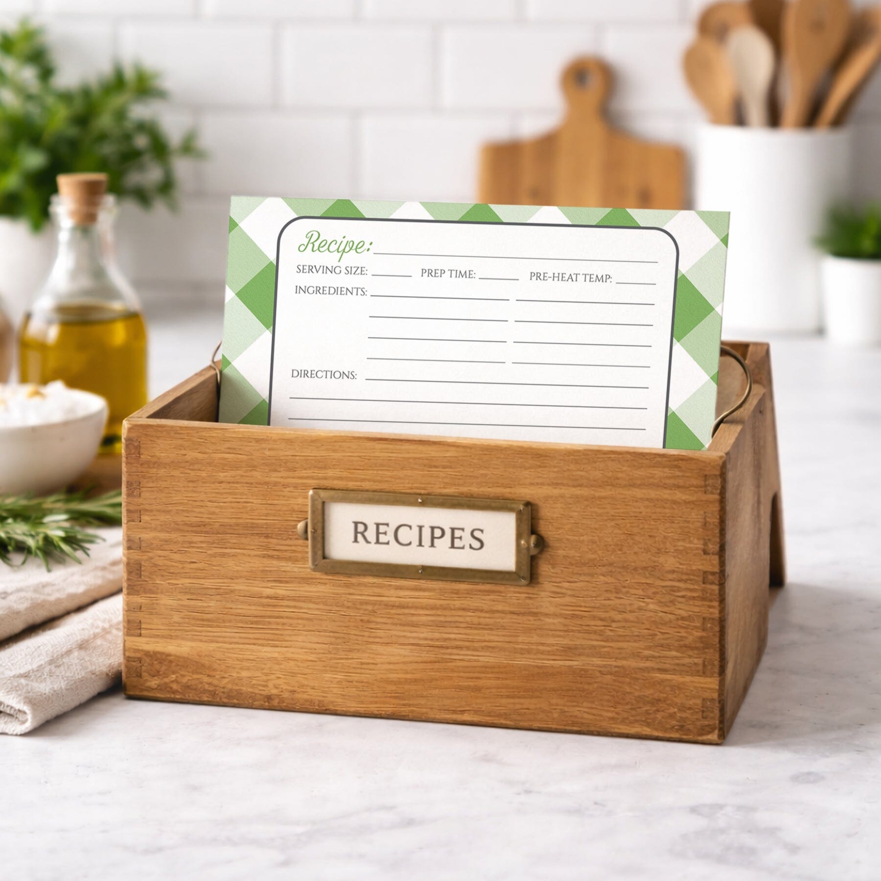 Wooden recipe box with a Green Gingham Recipe Card on top, kitchen setting in the background