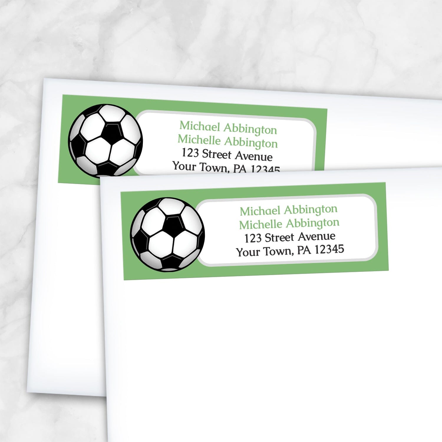 2 Green Soccer Ball Return Address Labels shown on white envelopes on a marble background