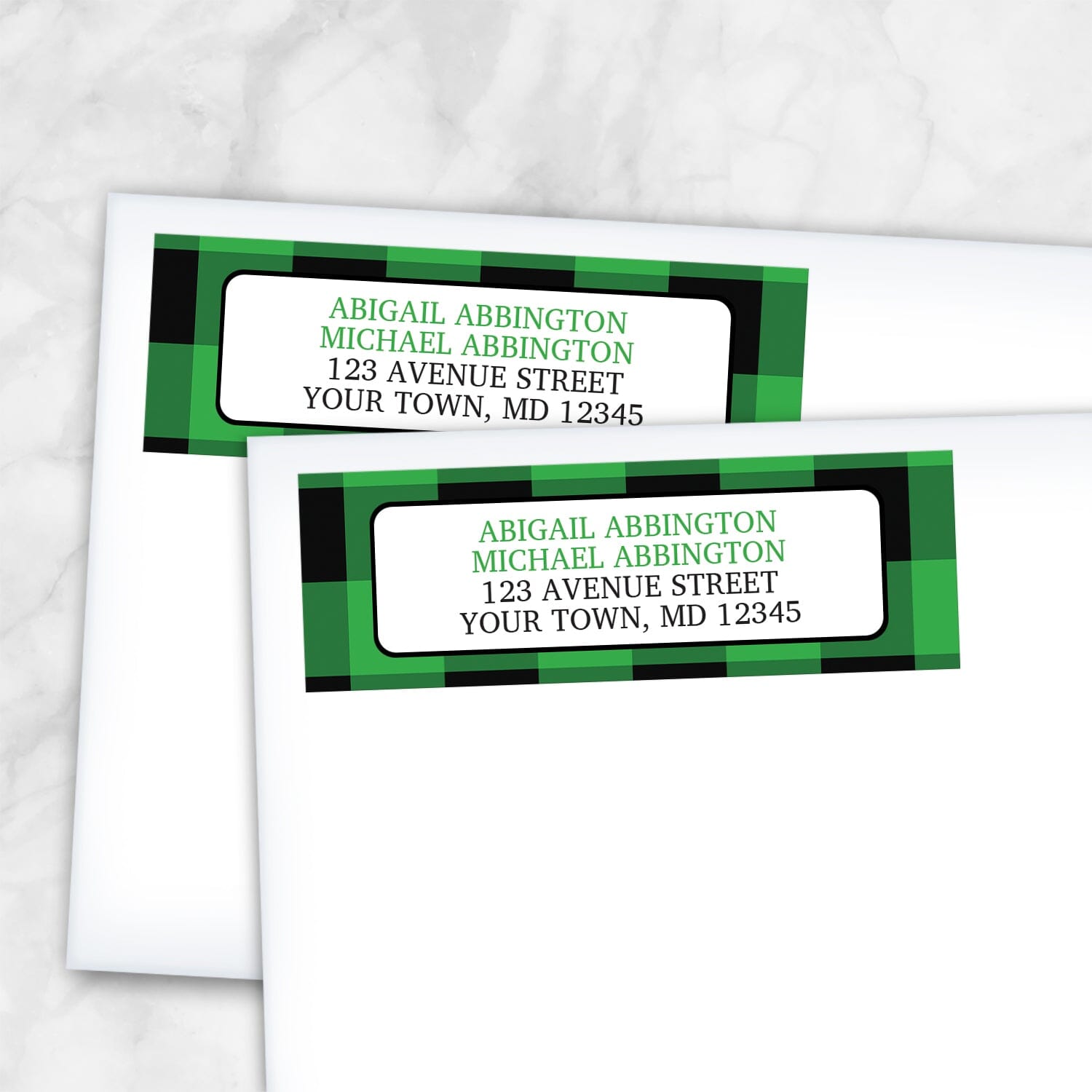2 Green and Black Buffalo Plaid Address Labels shown on white envelopes on a marble surface