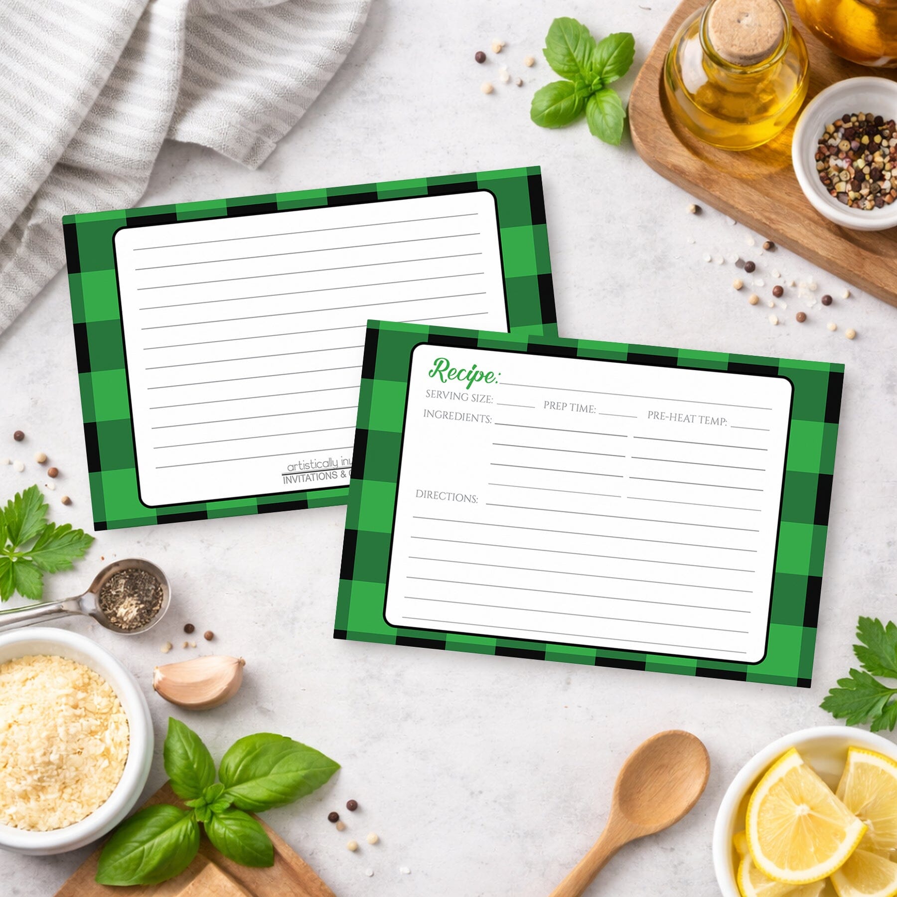Two Green and Black Buffalo Plaid Recipe Cards with green checkered borders on a kitchen counter with ingredients.