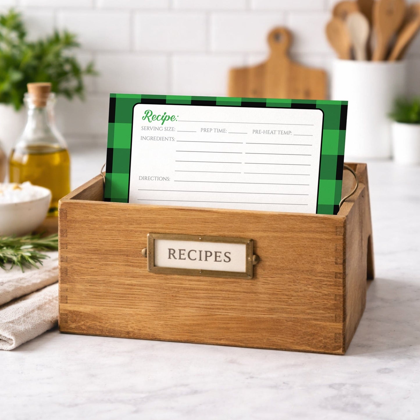 Wooden recipe box with a Green and Black Buffalo Plaid Recipe Card on a kitchen counter.