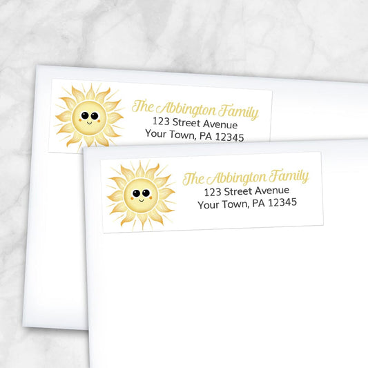 Happy Sun Address Labels at Artistically Invited. Example of labels on envelopes. These address labels are designed with an illustration of a cute and smiling, happy sun on the left side. Your personalized return address is custom printed in yellow and black over white.