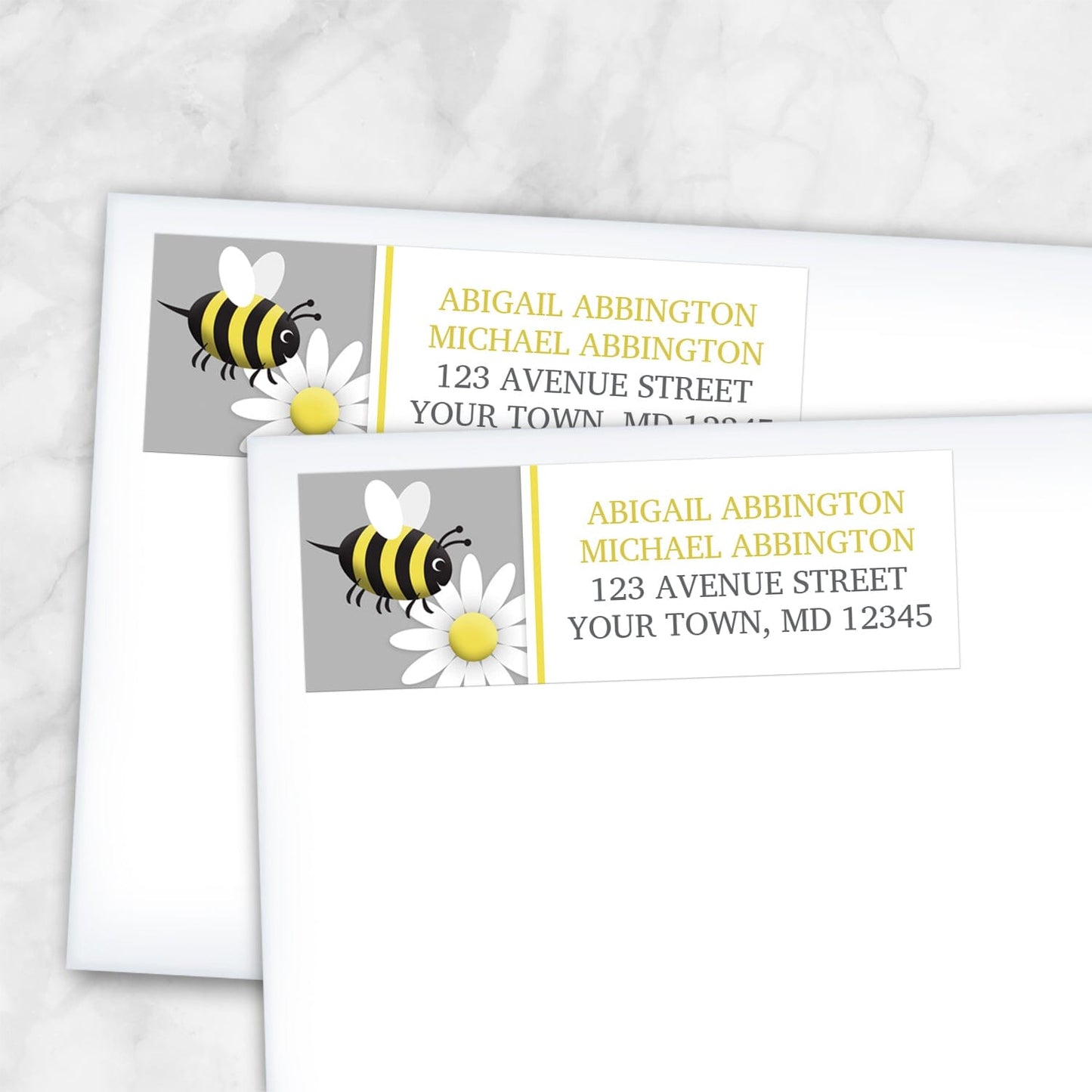 Happy Bee and Daisy Address Labels shown on two envelopes over a marble surface.