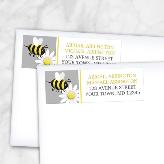 Happy Bee and Daisy Address Labels shown on two envelopes over a marble surface.