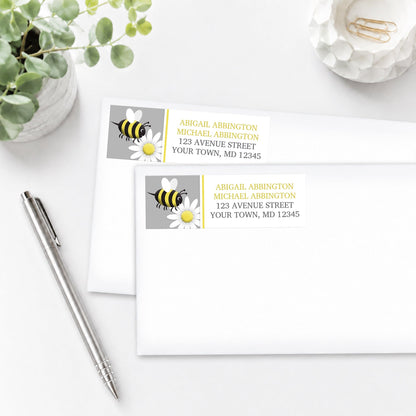 Happy Bee and Daisy Address Labels on two white envelopes with a pen and a plant.