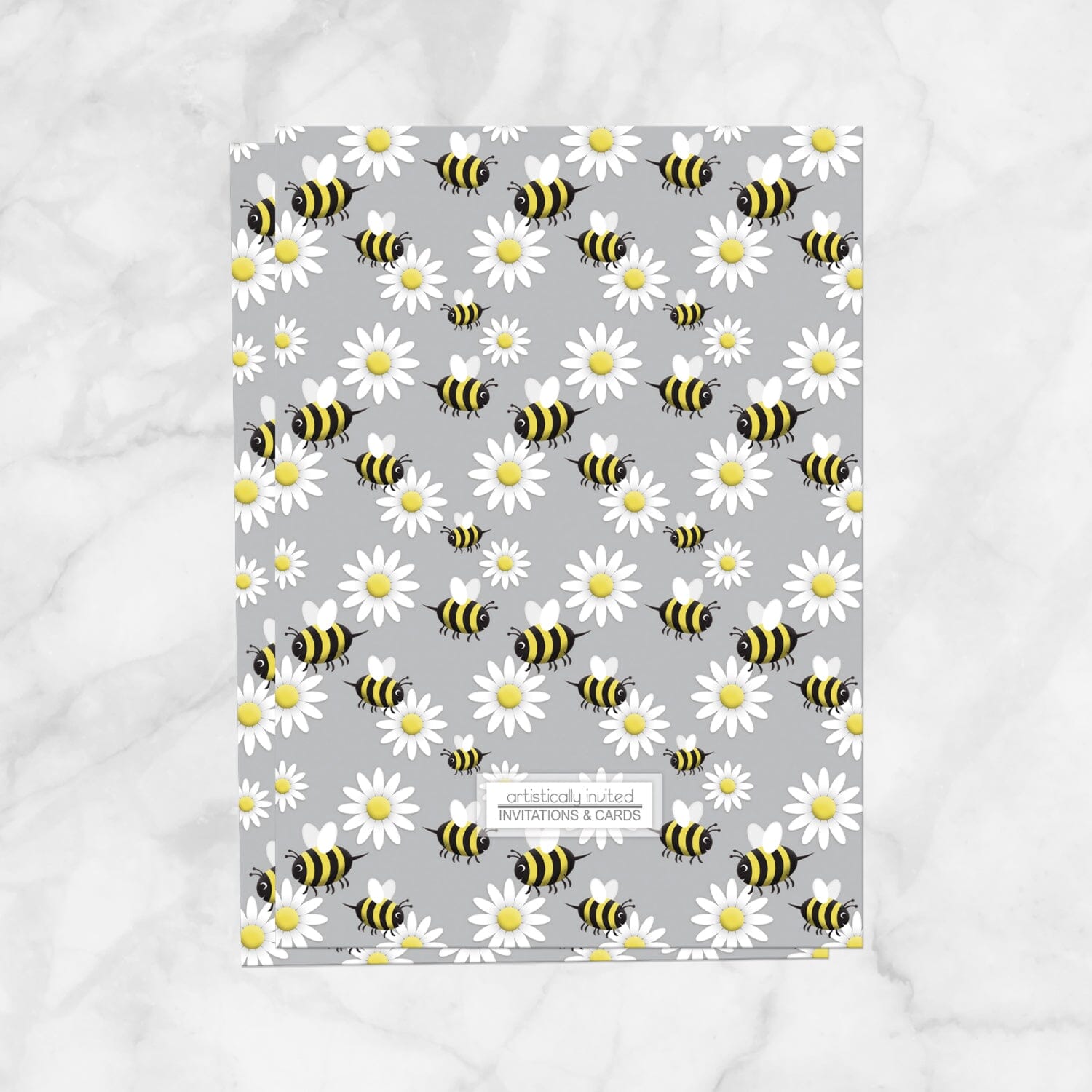 The backside of the invitations is printed with the bee and daisy pattern when the printed invitation upgrade is purchased