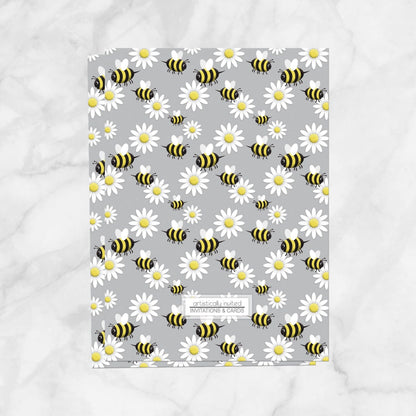 The backside of the invitations is printed with the bee and daisy pattern when the printed invitation upgrade is purchased