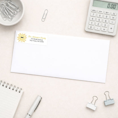 White envelope shown with the personalized Happy Sun Address Label on a desk with office supplies
