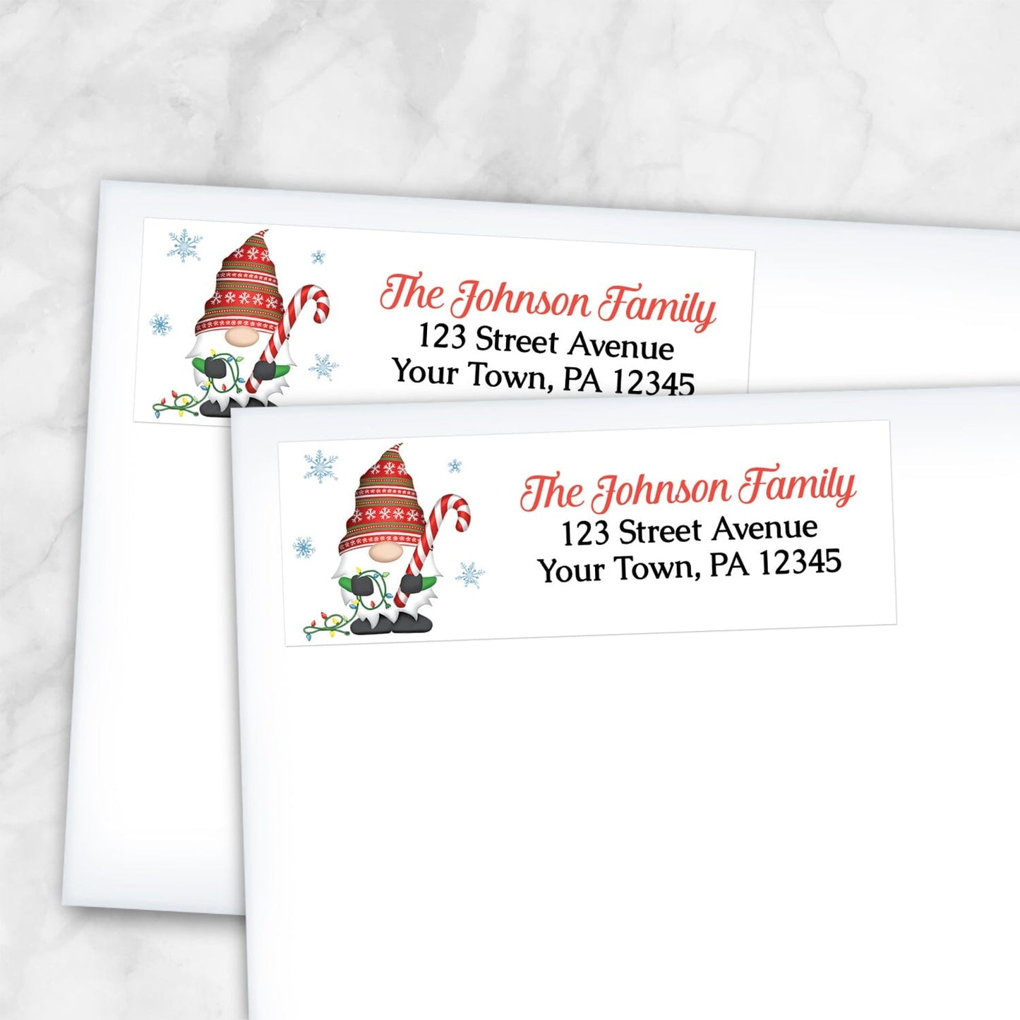 2 Holiday Candy Cane Gnome Address Labels on white envelopes over a marble surface