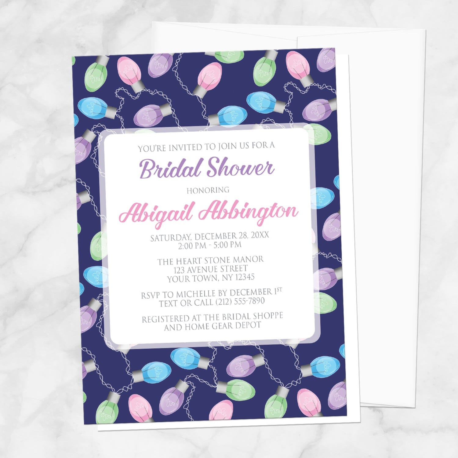Holiday Lights Pattern Bridal Shower Invitation shown on a marble surface with a white envelope.