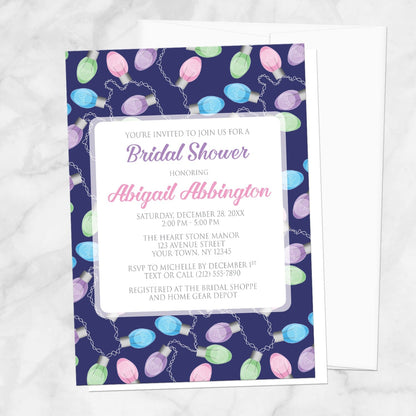 Holiday Lights Pattern Bridal Shower Invitation shown on a marble surface with a white envelope.