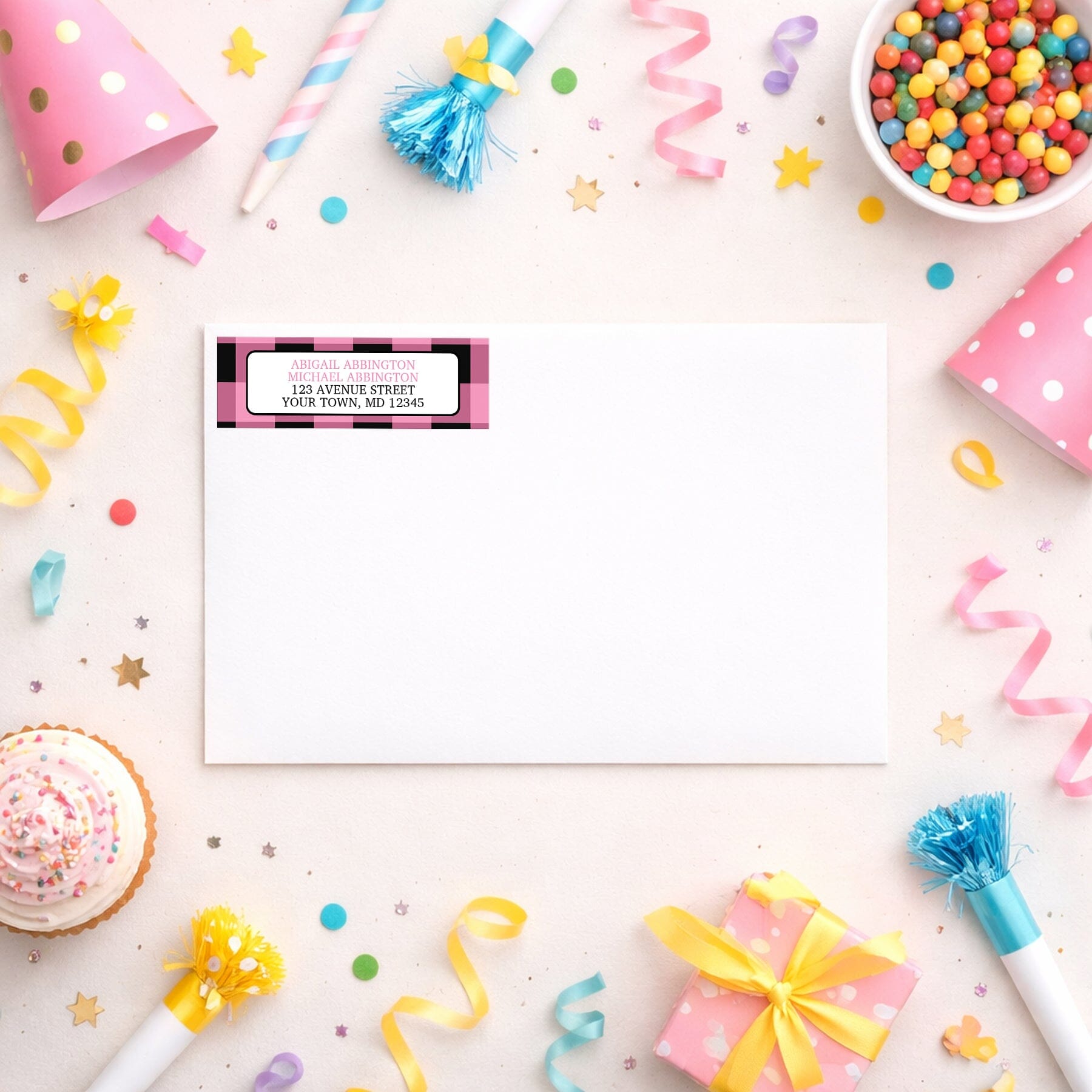 Light Pink and Black Buffalo Plaid Address Label shown on a white envelope with party supplies