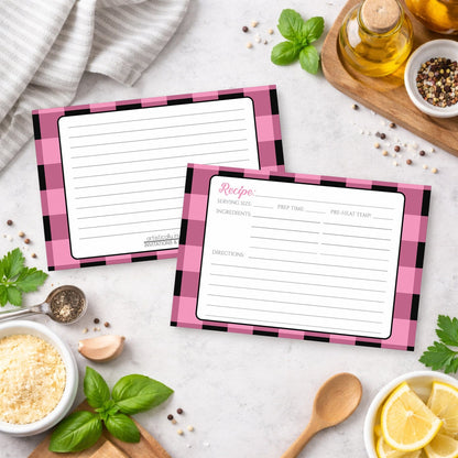 Two Light Pink and Black Buffalo Plaid Recipe Cards on a kitchen counter with ingredients.