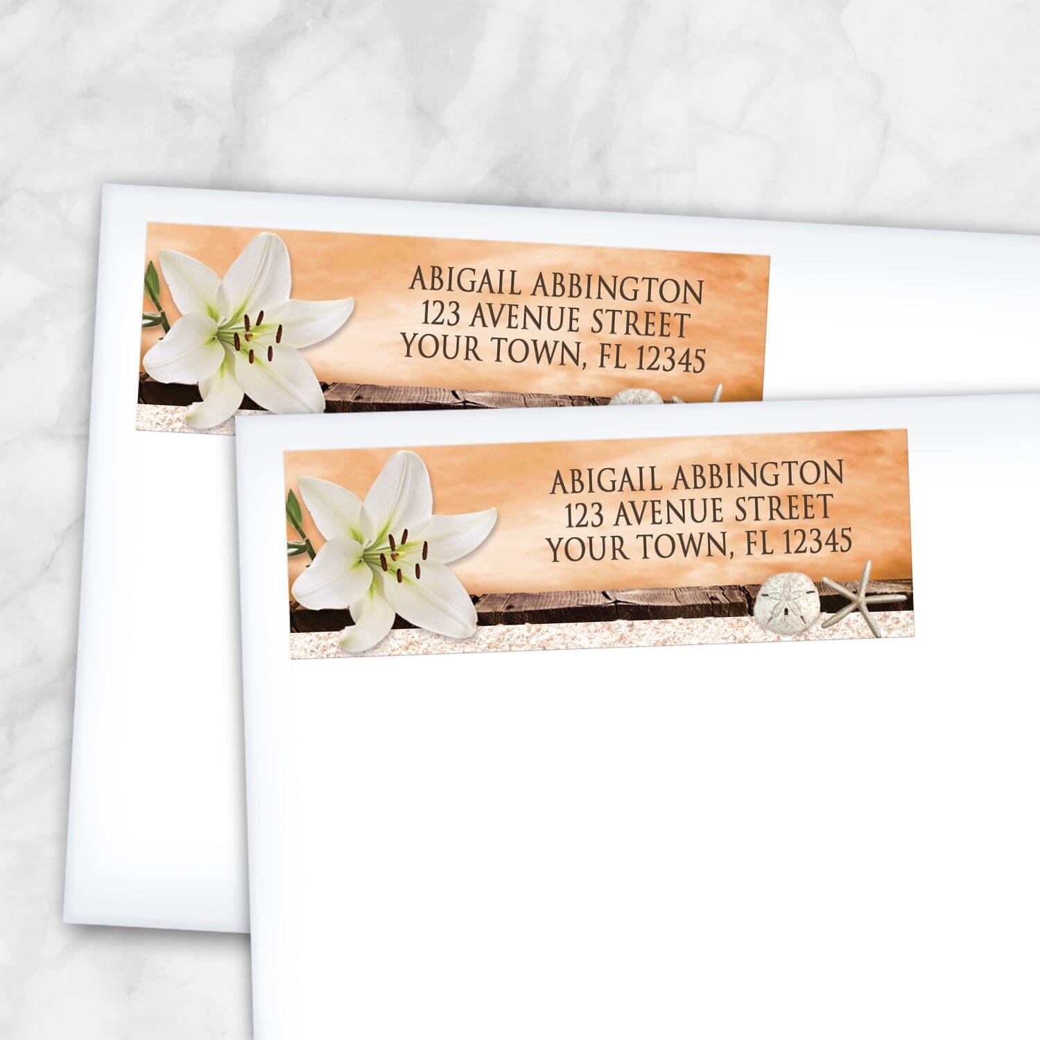 2 Lily Seashells and Sand Autumn Beach Address Labels shown on white envelopes on a marble surface